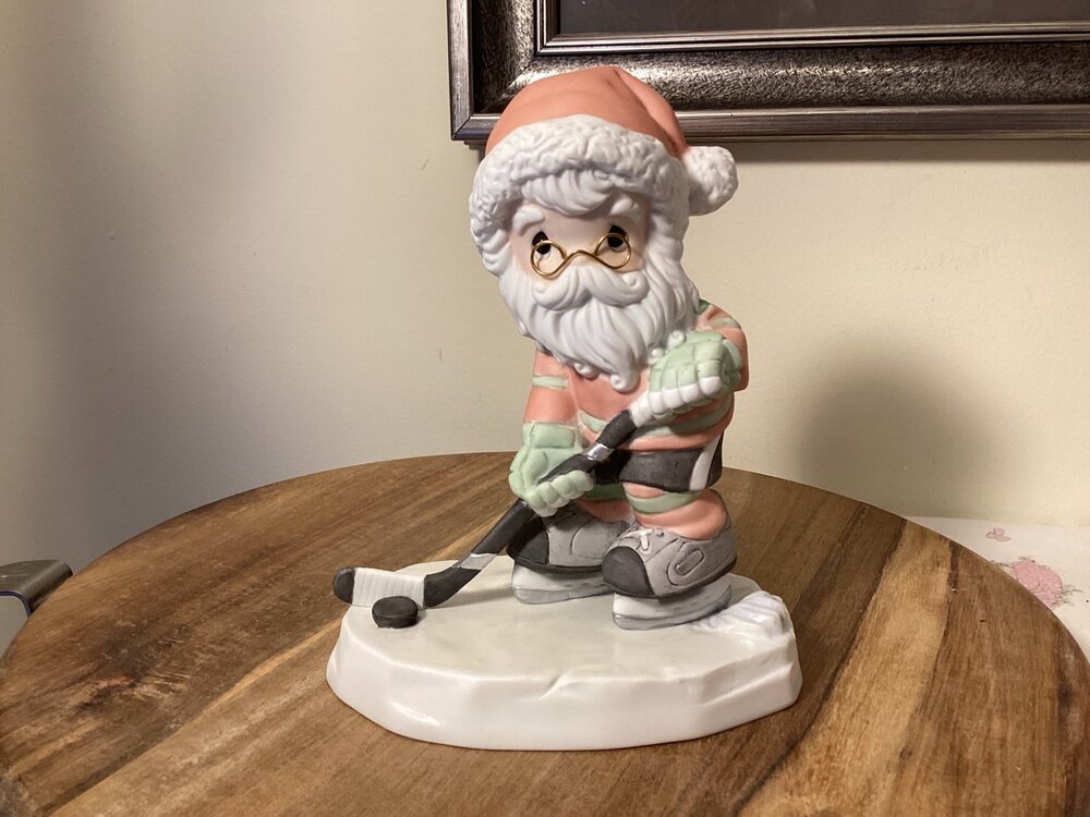 Precious Moments Checking up on your holiday / Santa playing Hockey